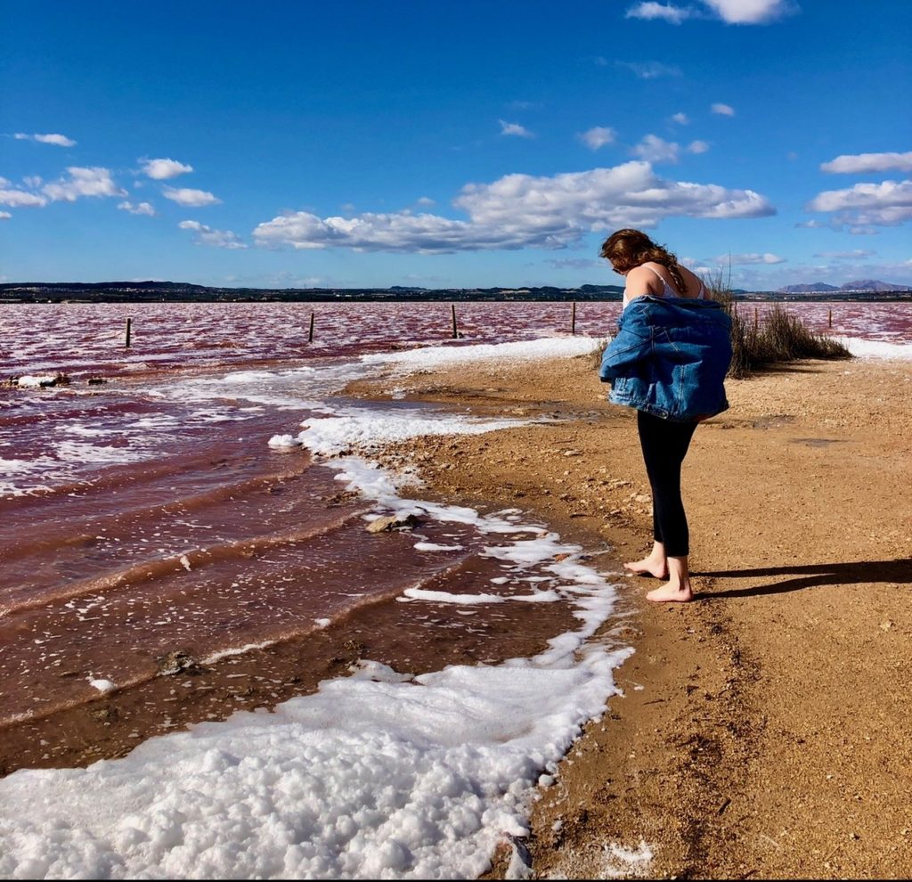 In order to protect the pink lake in Spain, it is forbidden to swim in the lake. But that doesn't mean you can't walk barefoot on the beach and take in the vibrant colors 