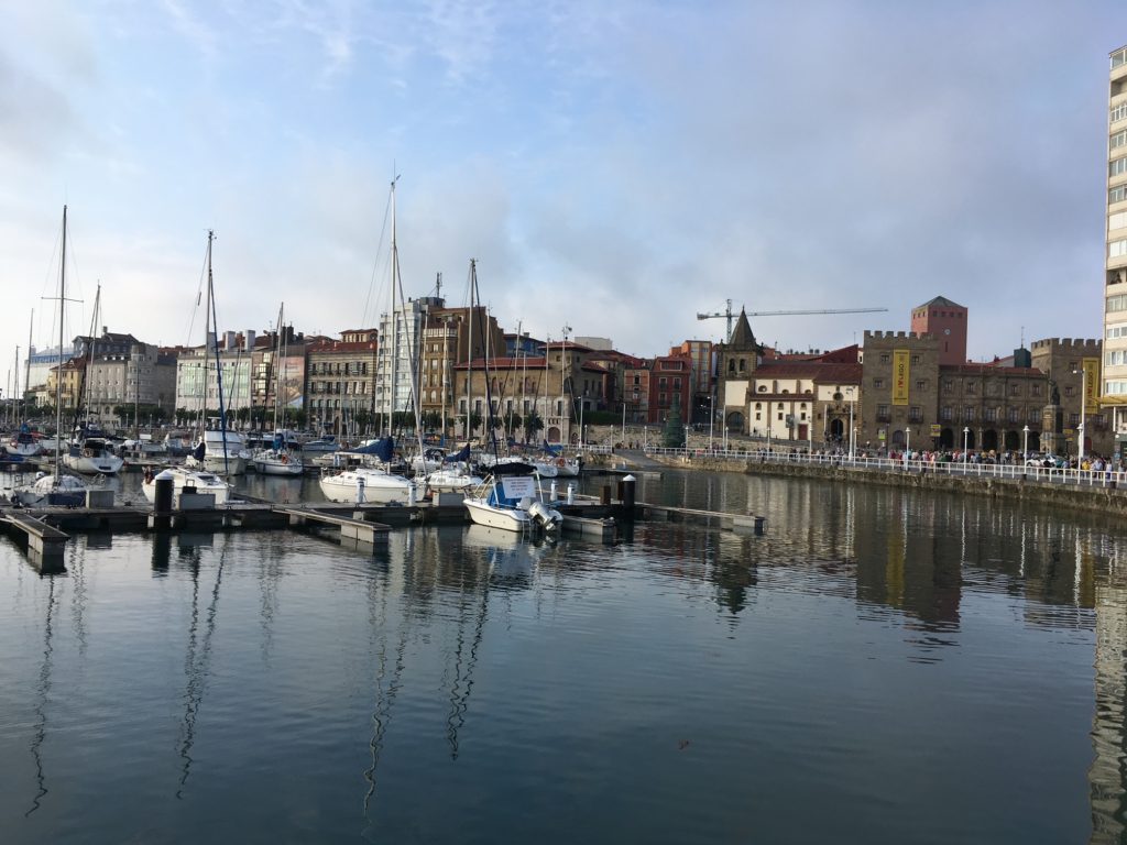 The harbor of Gijón is filled with cute boats, framed with the adorable historic city center and is a great place to rent watersport vehicles.