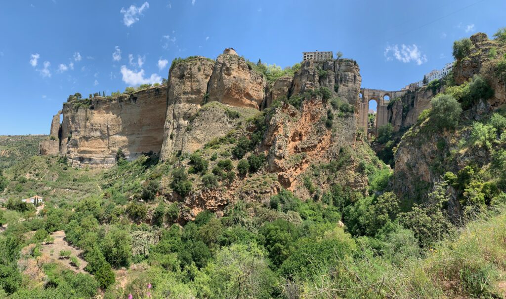 A beautiful view of steep cliffs and the Puente Nuevo that can be seen on a Ronda, Spain Day trip.
