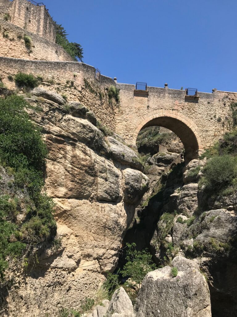 Admire the structure of the old bridge in Ronda, from below. 