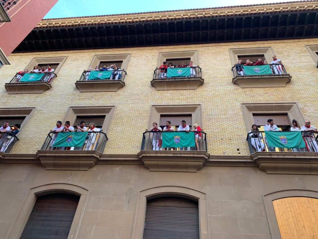 Spectators of the Running of the Bulls look out on the race from the balconies near the starting point. La Fiesta de San Fermín is known for viewing the races from the well-placed balconies. 